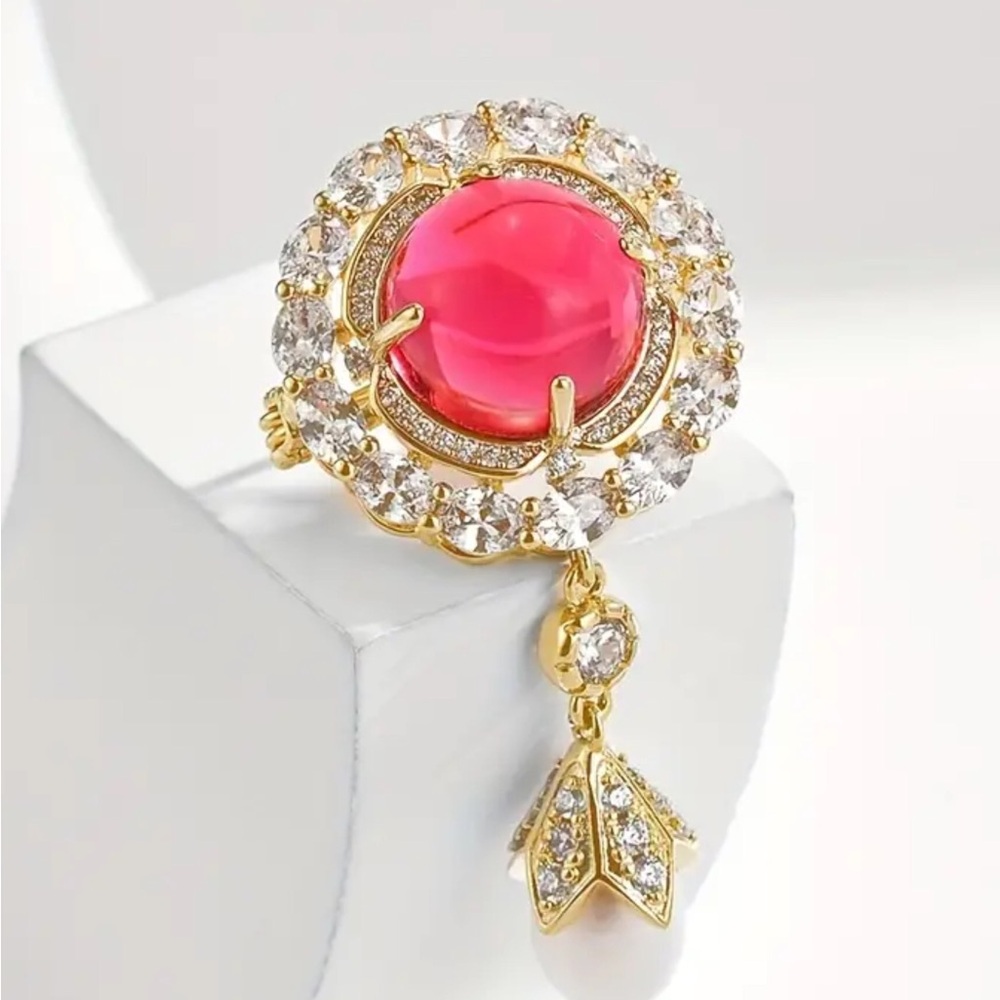 Gold tone brooch with synthetic stones